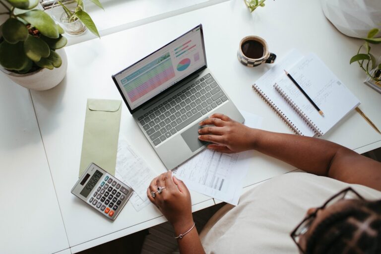 Business owner using a laptop while reviewing digital growth and search visibility strategy