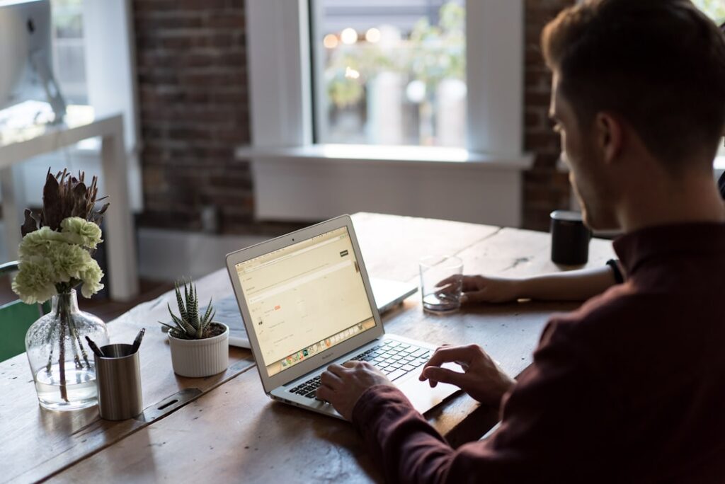 Business professional reviewing website and AI search visibility performance on a laptop