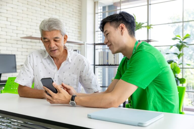 People using a smartphone together, representing local business discovery and AI-powered recommendations
